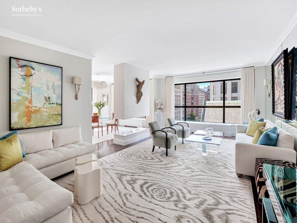 1020 Park Avenue #10C — substantial corner living room with Park Avenue exposure through the casement windows; designer-staged for the Sotheby's listing
