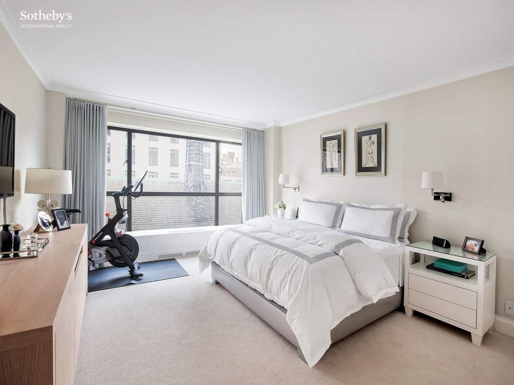 Primary bedroom — substantial scale, corner-residence two-exposure light, prewar-style architectural register