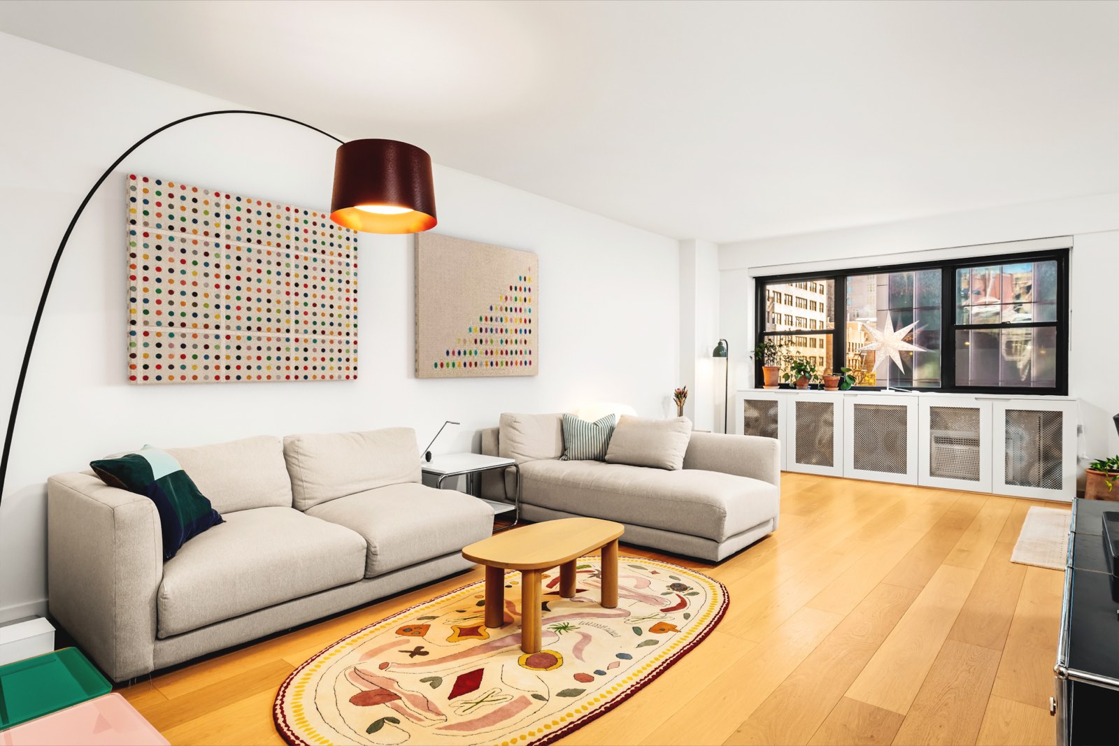 The living room toward the windows, with custom cabinetry along the window wall