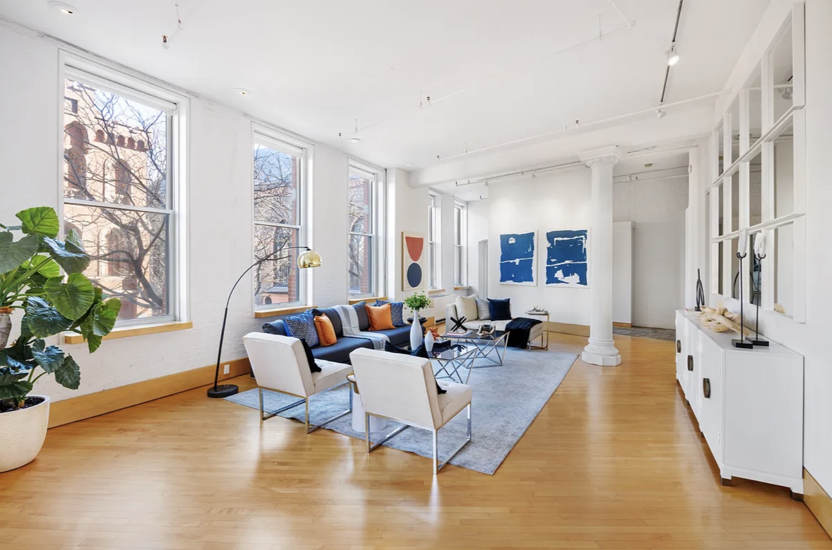 A second angle of the living room — full cast-iron column architectural detail, open-loft proportions