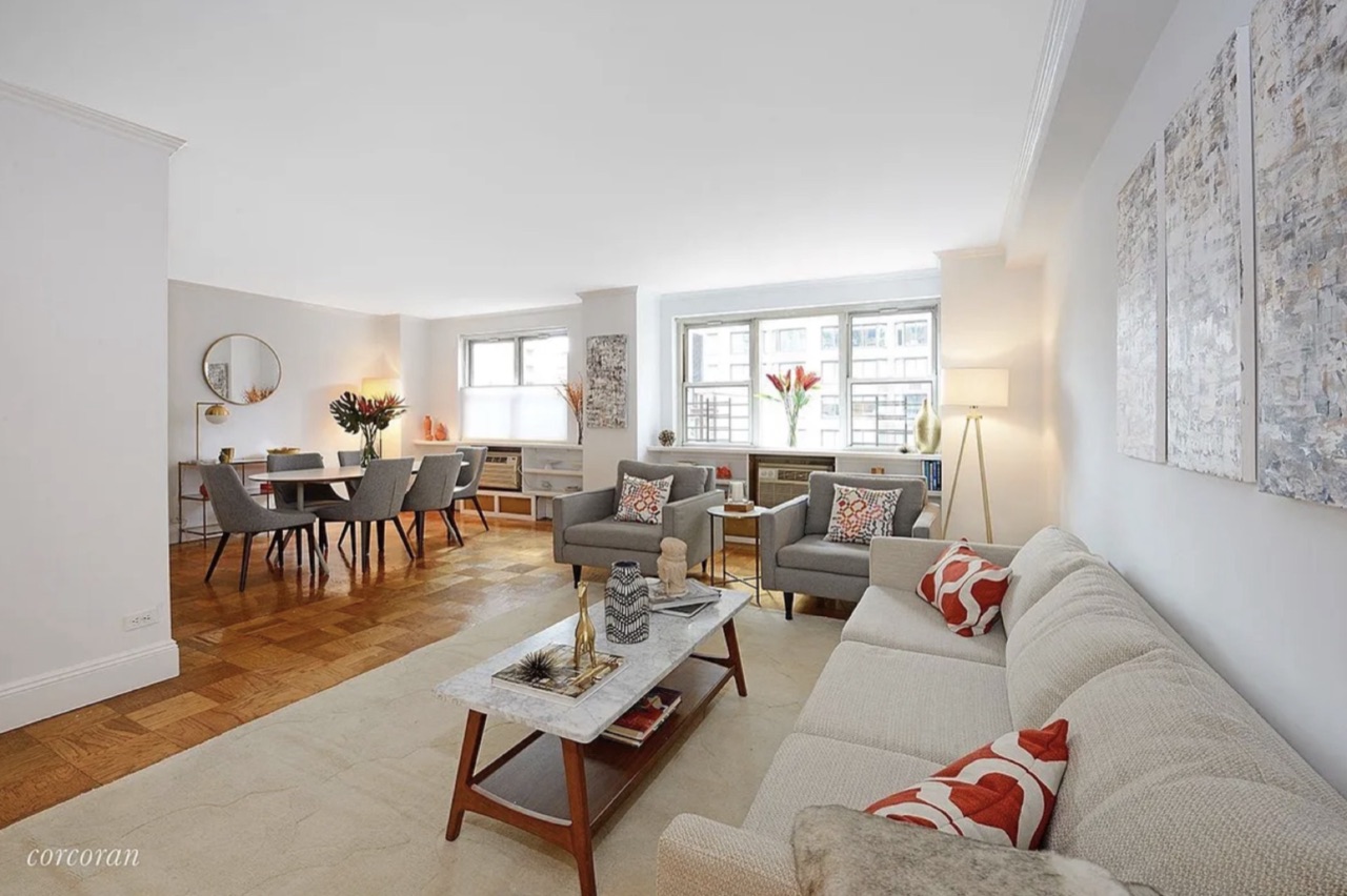 333 East 79th Street #6YZ — the combined living-and-dining program with the dining area at left, the open-flow sitting room at right, and the east-line window exposure delivering city light through the principal entertaining space