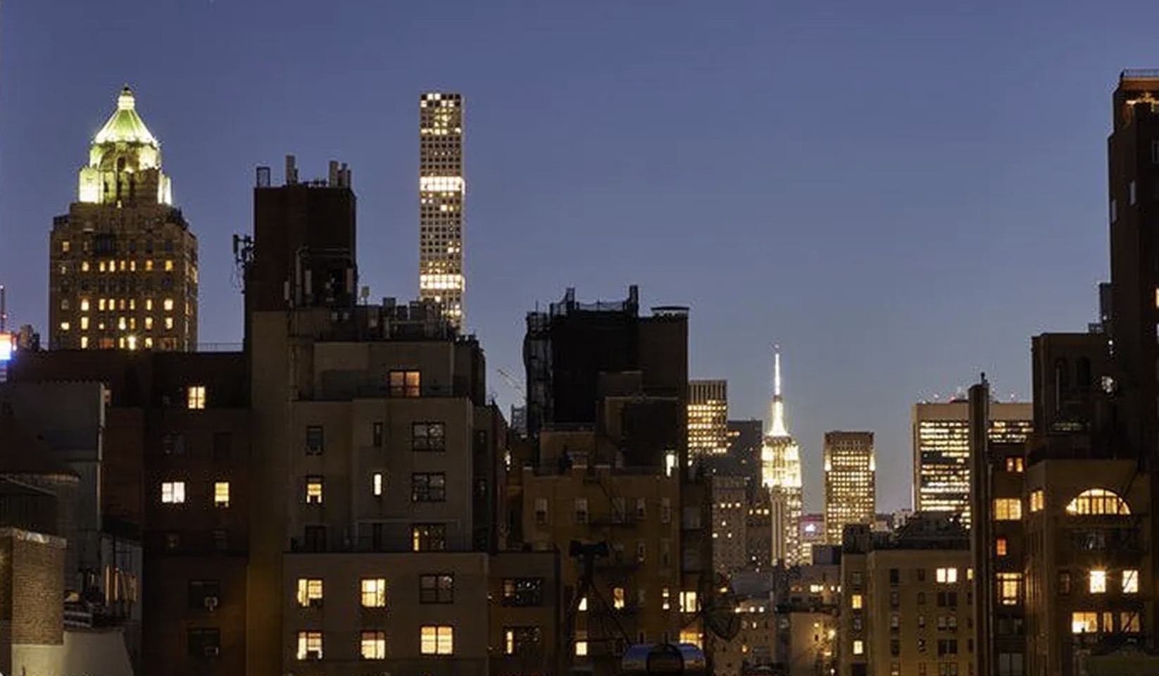 The view from the apartment — Manhattan at night, including Midtown skyline