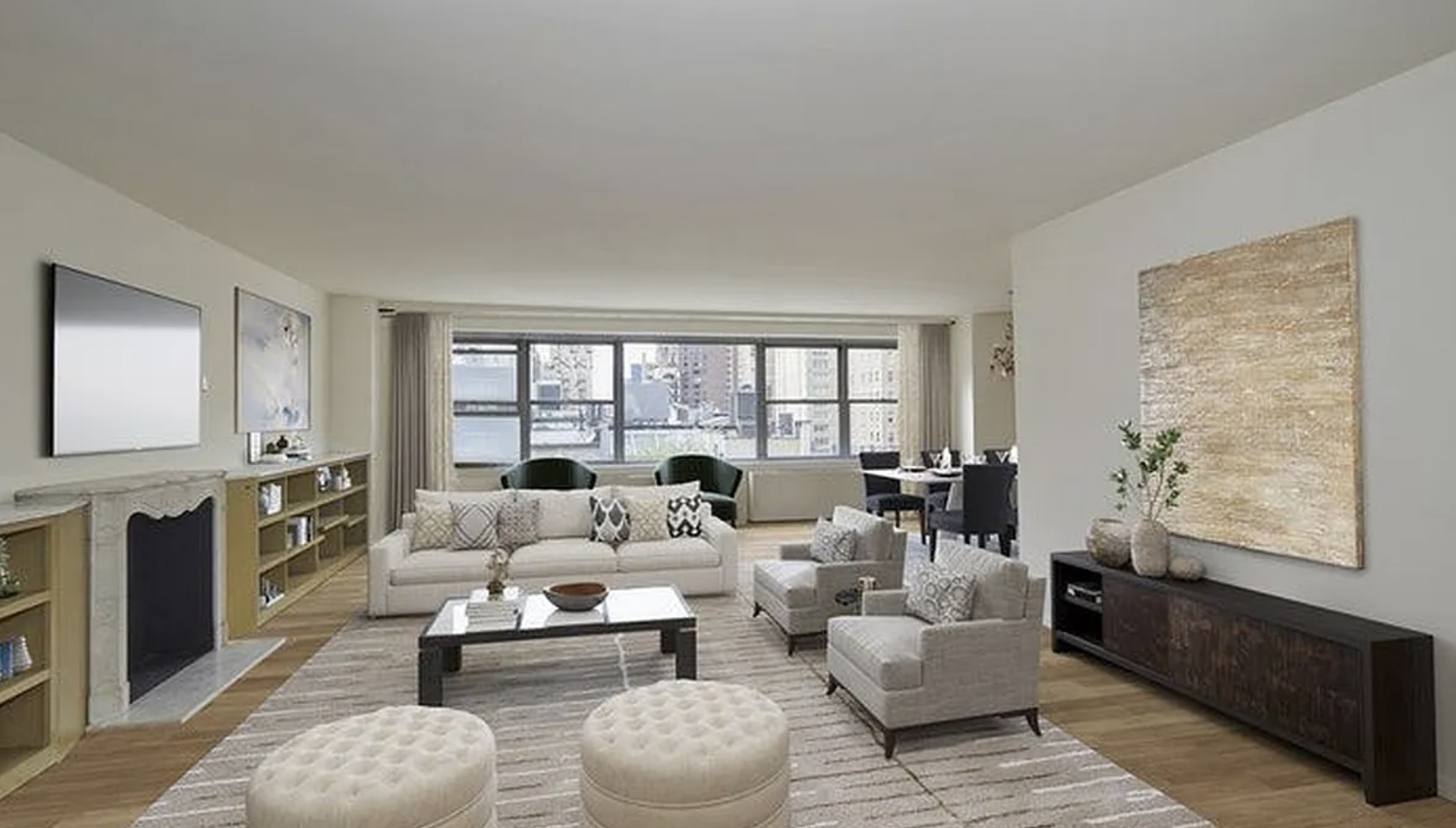 The living room at 8 East 83rd #9/10D — marble fireplace, custom millwork, open-room scale on the lower floor