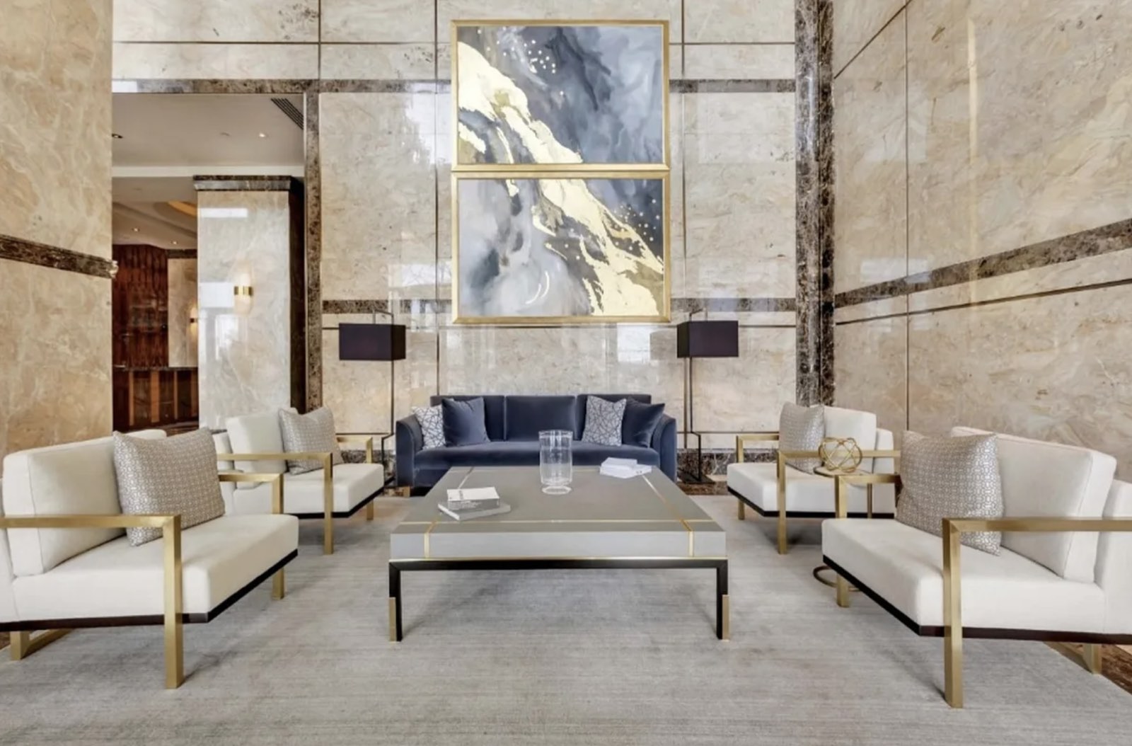 The marble lobby at 845 United Nations Plaza, with a seating area beneath double-height stone walls